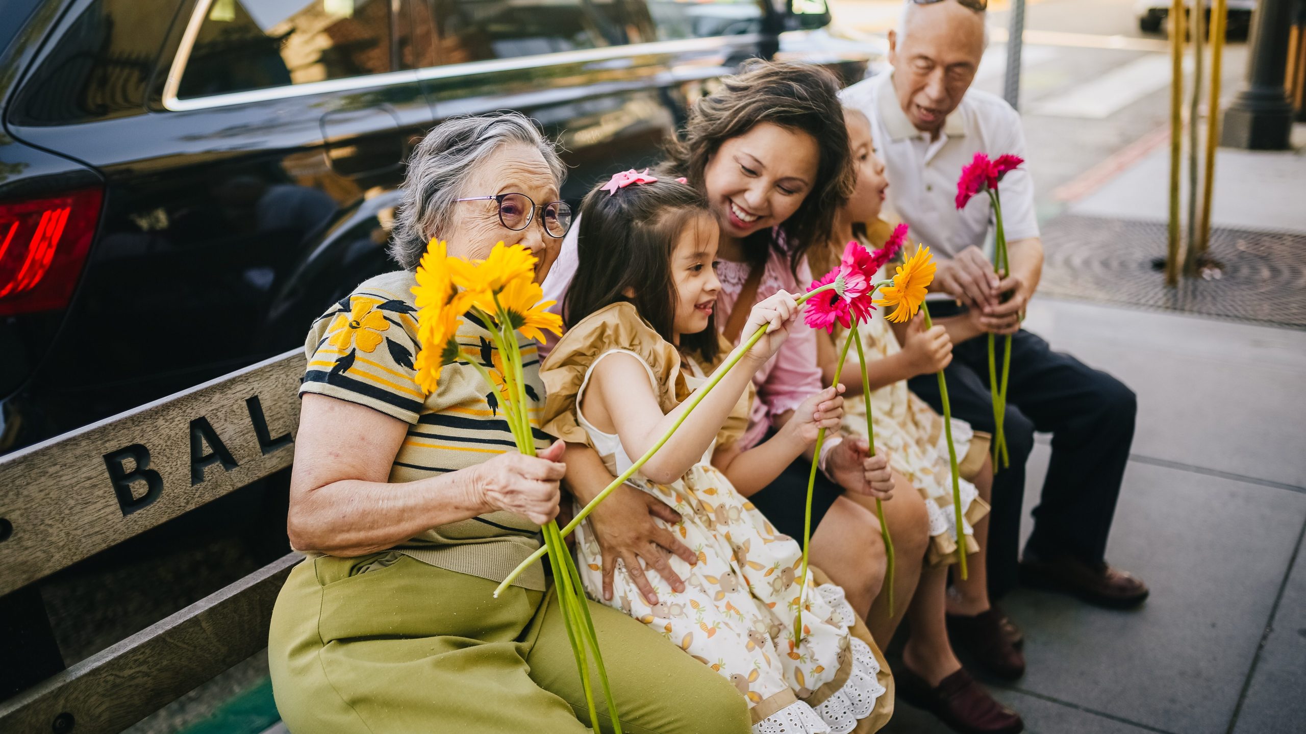 grandparents with grandkids and flowers